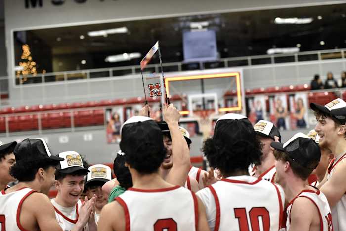 Mustang players celebrate after the Broncos claimed the boys championship of their Mustang Holiday Classic on Dec. 30, 2023.